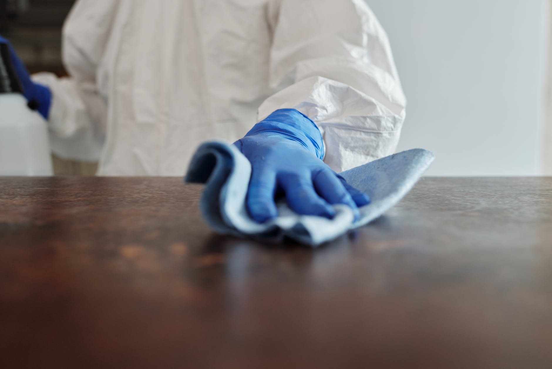 close up photo of person cleaning the table